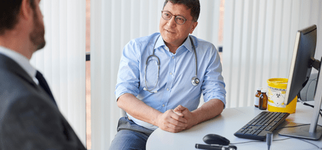 male GP talking to patient